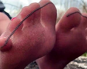 goddess teases feet in tan pantyhose amid spring forest