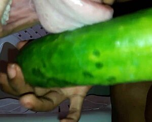 Young ebony mel masturbates intensely with thick cucumber toy