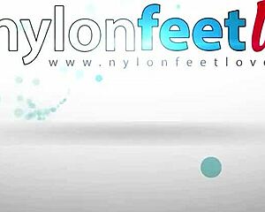 lesbians rubbing feet through pantyhose on the bed