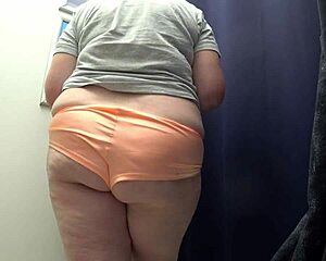 check out this pawg milf's huge ass in satin panties changing in the fitting room