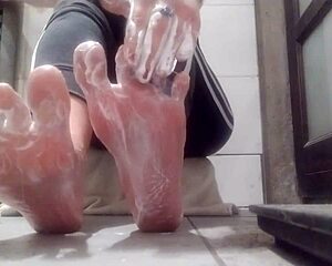 check out this sexy woman showing her feet all lubed up