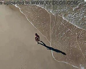 Wanna join that beach walk with her big tits bouncing?