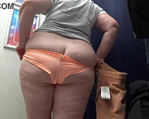 check out this pawg milf's huge ass in satin panties changing in the fitting room