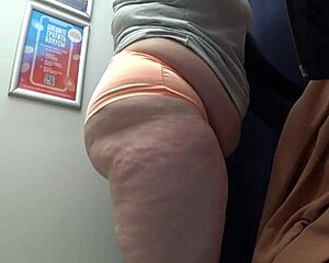 check out this pawg milf's huge ass in satin panties changing in the fitting room