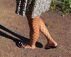 skinny teen lifts skirt flashing small tits ass plug through fishnet pantyhose outdoors