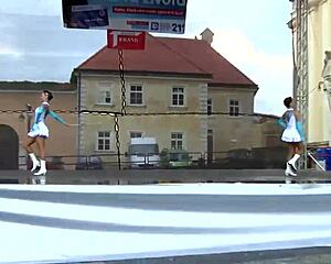 Two nice majorettes showcase cheerleading skills side by side