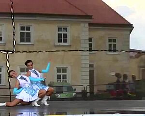 Two nice majorettes showcase cheerleading skills side by side