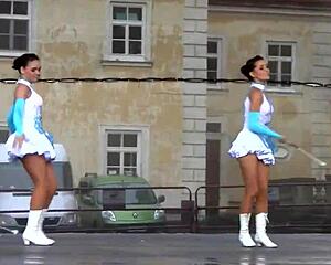 Two nice majorettes showcase cheerleading skills side by side