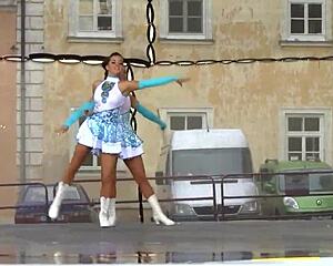 Two nice majorettes showcase cheerleading skills side by side