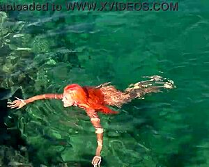 naked girl splashing around in blue water