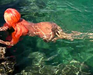 naked girl splashing around in blue water