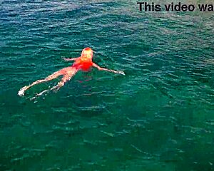 naked girl splashing around in blue water