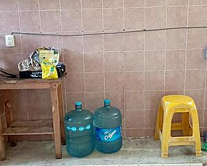 Chubby stepmom washes dishes and cleans kitchen