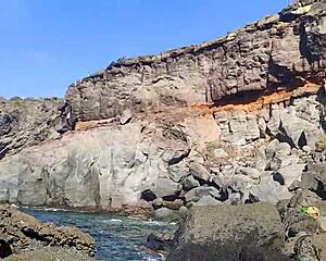 skinny slut gives deep blowjob on seaside rocks, tits out