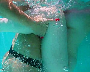 Lesbian strap-on fucks underwater with ass licking