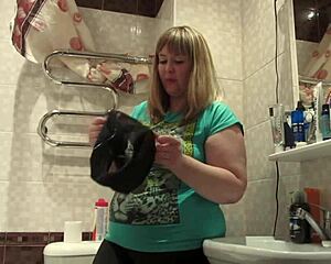 chubby milf sniffs panties fingers hairy pussy hides them inside on toilet