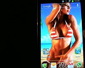 A lively interactive wallpaper features beach bikini boobs bouncing on your mobile.