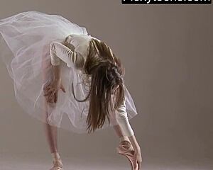Blonde gymnast demonstrates impressive acrobatic stretches and poses