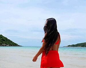 Pretty tanned brunette in orange bikini flashes fingering pussy publicly on beach?