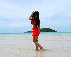 Pretty tanned brunette in orange bikini flashes fingering pussy publicly on beach?