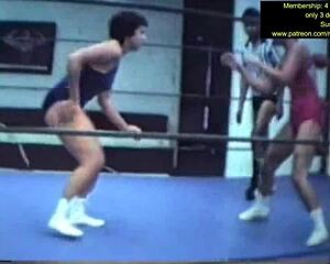 mixed wrestling match unfolds with intense grapples and holds