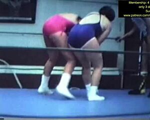 mixed wrestling match unfolds with intense grapples and holds