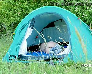 nudist milf sits in the tent