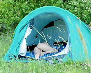 nudist milf sits in the tent