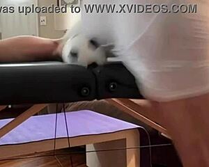 Groin stretch in tight spandex shorts with mini football soccer ball on stool and table slowed down time lapse